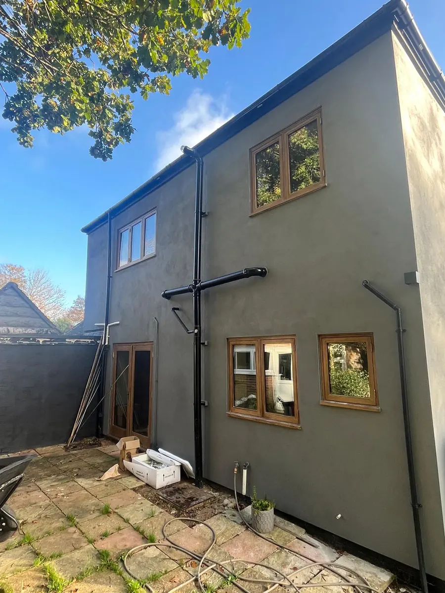 A rendered rear extension with oak framed windows