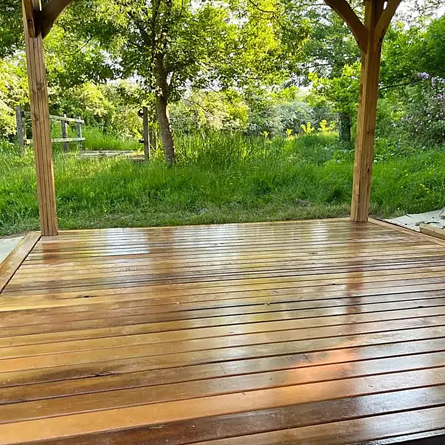 New timber decking under an oak gazebo in a garden