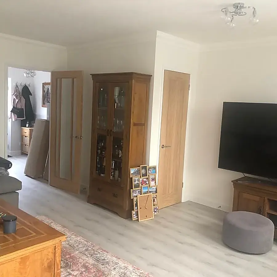 A renovated living room with oak furniture and new flooring