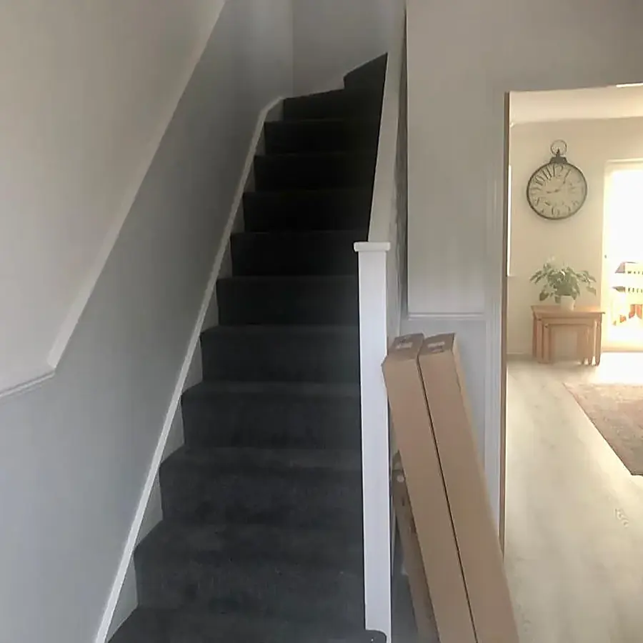 A newly decorated hall and staircase with grey carpet