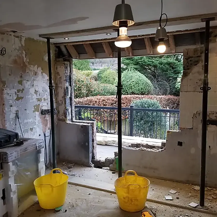 A room stripped back to brick with a new structural opening to the garden