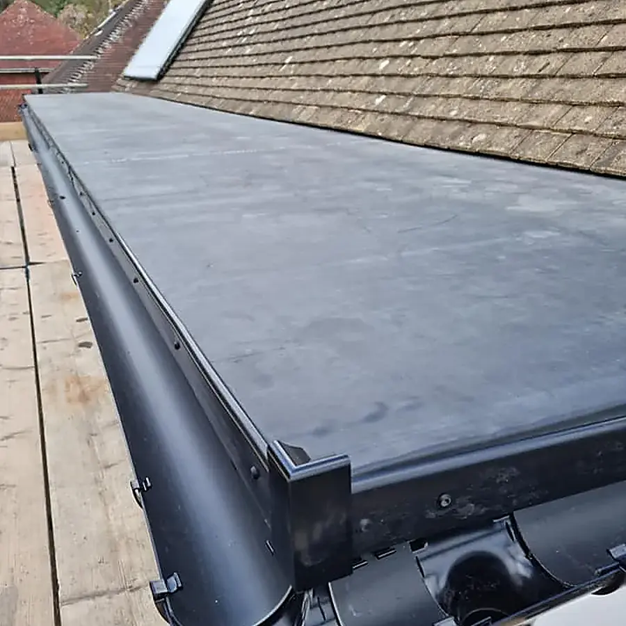 A new flat roof with black fascia and guttering