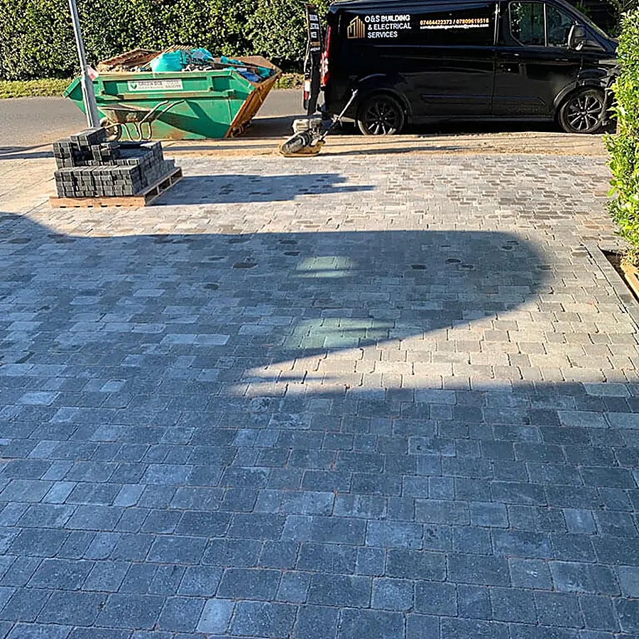 Charcoal block paving being laid on a driveway
