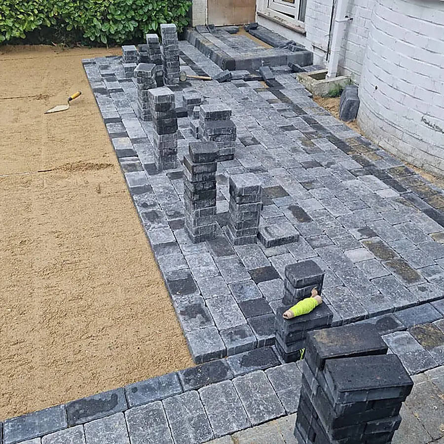 Block paving being laid on a screeded sand bed