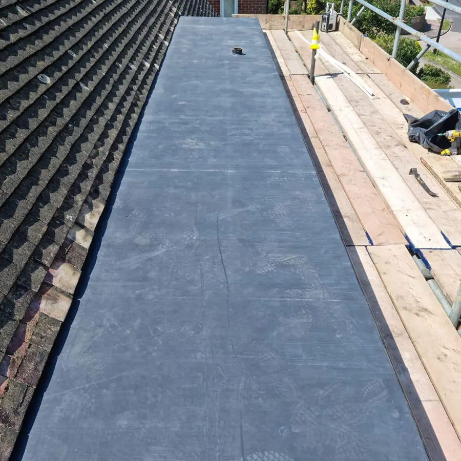 A long rubber flat roof finished on a rear extension