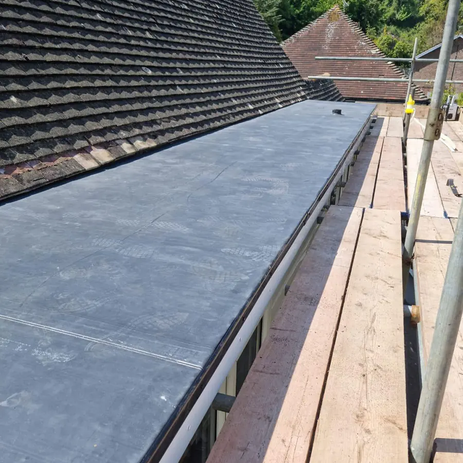 A rubber flat roof with the tiled roof above