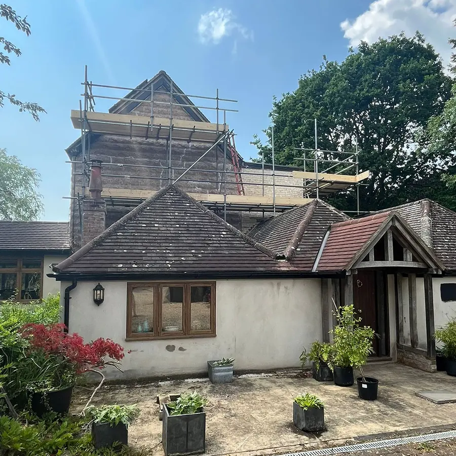 A bungalow roof opened up under scaffold for a loft conversion