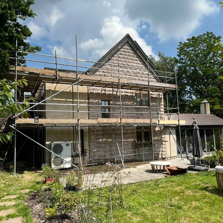 A house under scaffold being rendered