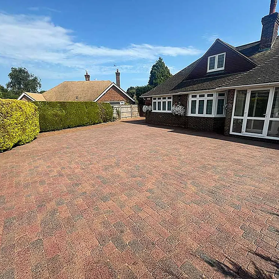 A block paved driveway sweeping up to a bungalow