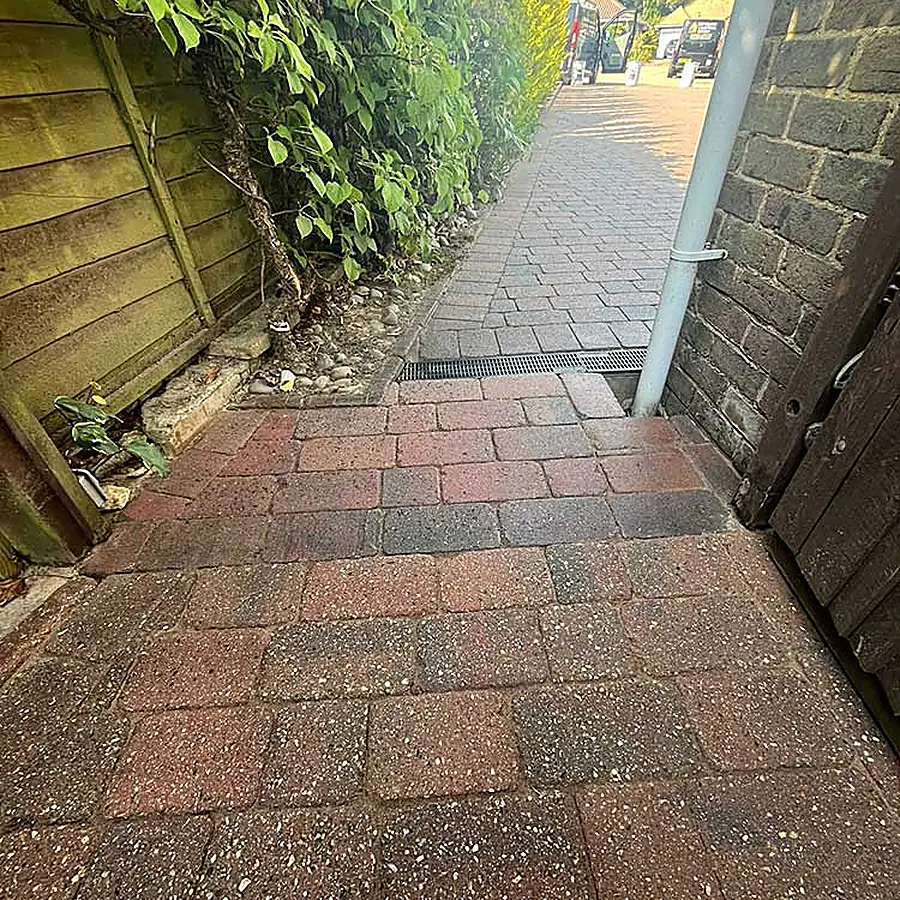 A block paved path beside a house