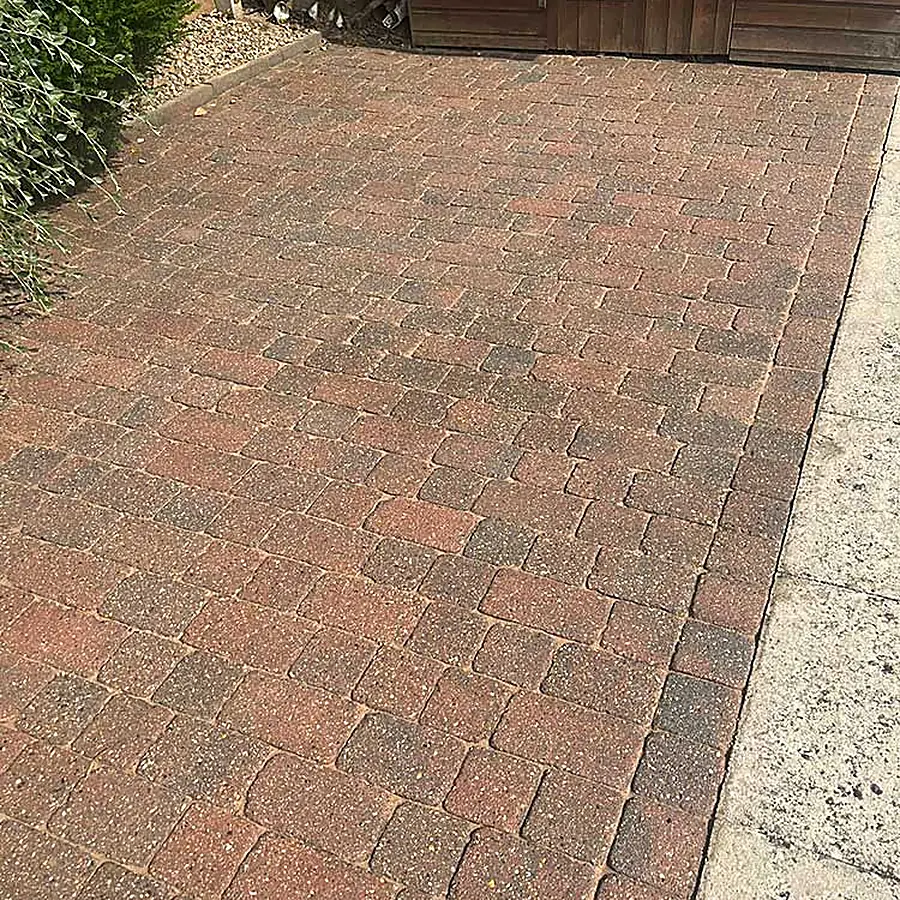 Block paving laid up to a timber shed