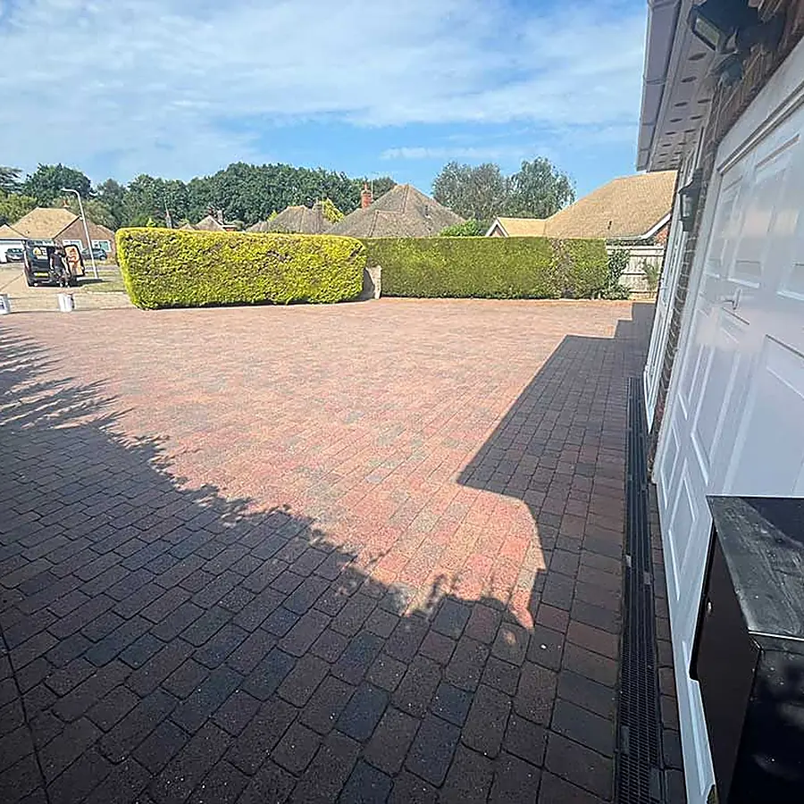A block paved driveway to a garage
