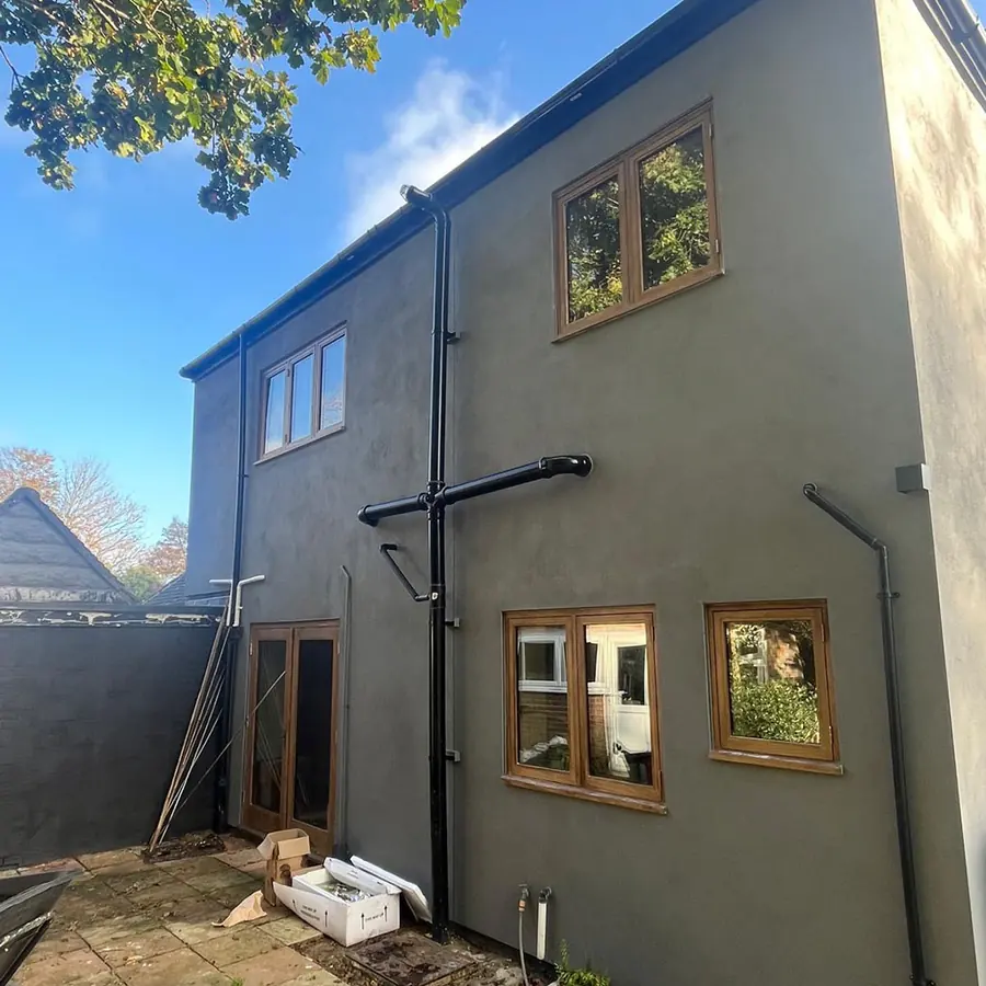 A rendered rear extension with oak framed windows
